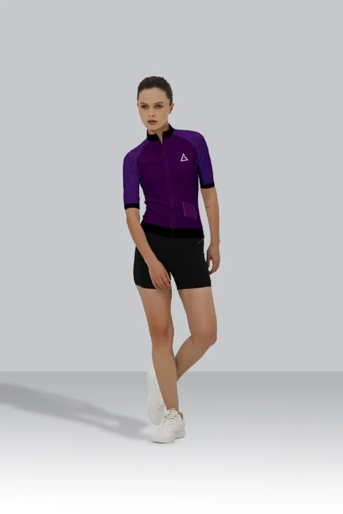 The cyclist wears a purple and black custom race-fit cycling jersey paired with black shorts, showcasing a sleek aerodynamic design.