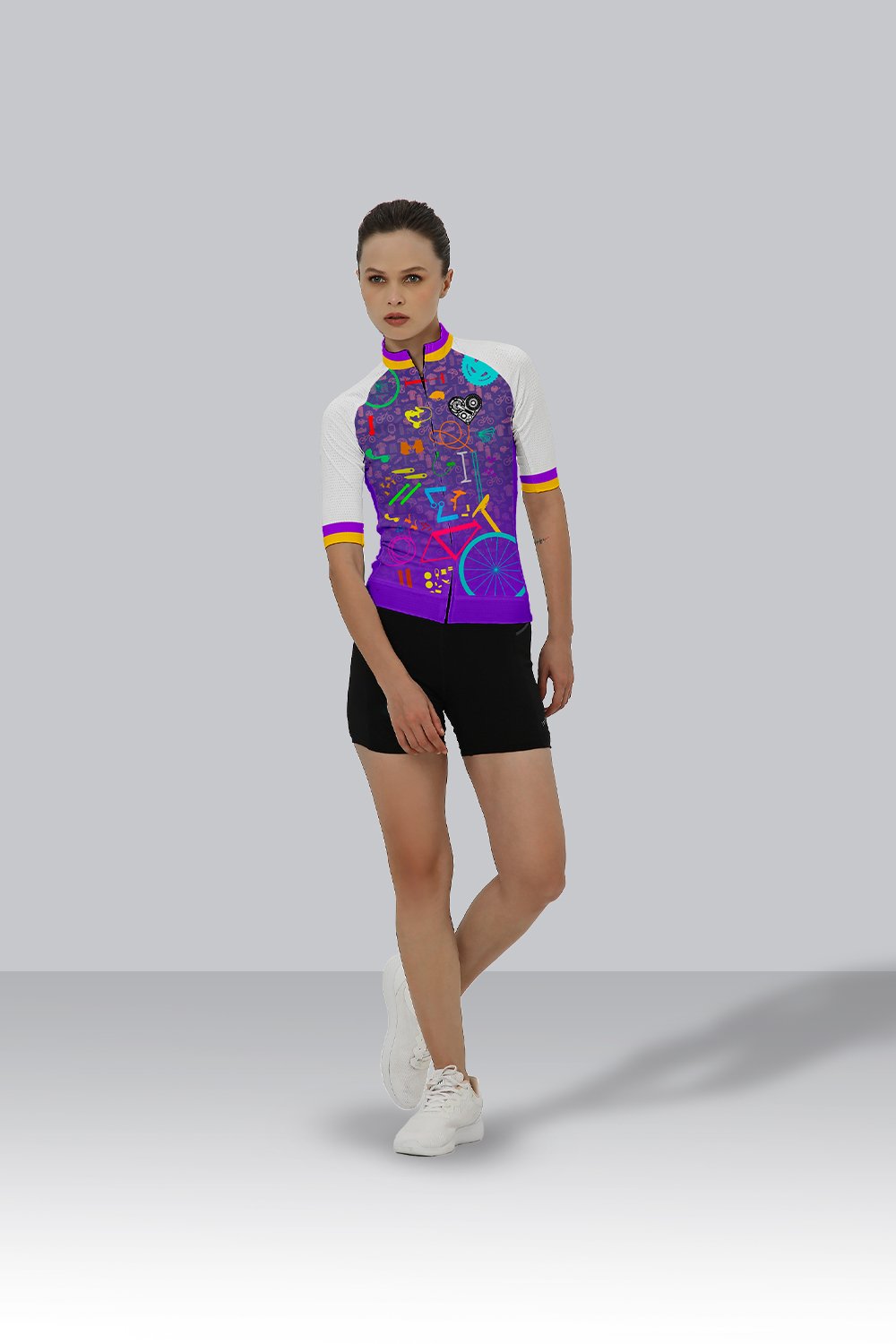 Cyclist wearing a Vivid Velocity race fit cycling jersey with a bold purple base and multicolored geometric design.